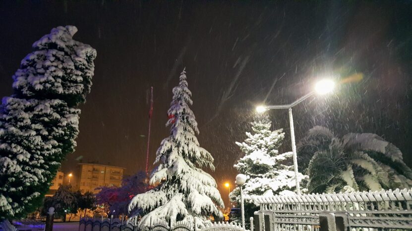 Snowfall in the city in the evening